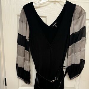 Bebe black stretchy knit mini dress with dark and light gray sleeves